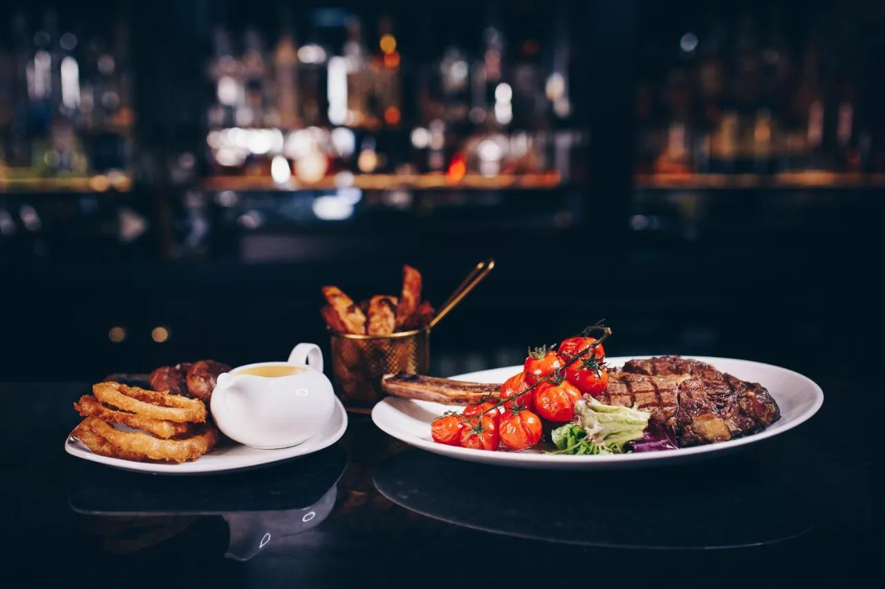 two plates of food and a cup of coffee on a table at The County Aparthotel in Newcastle upon Tyne