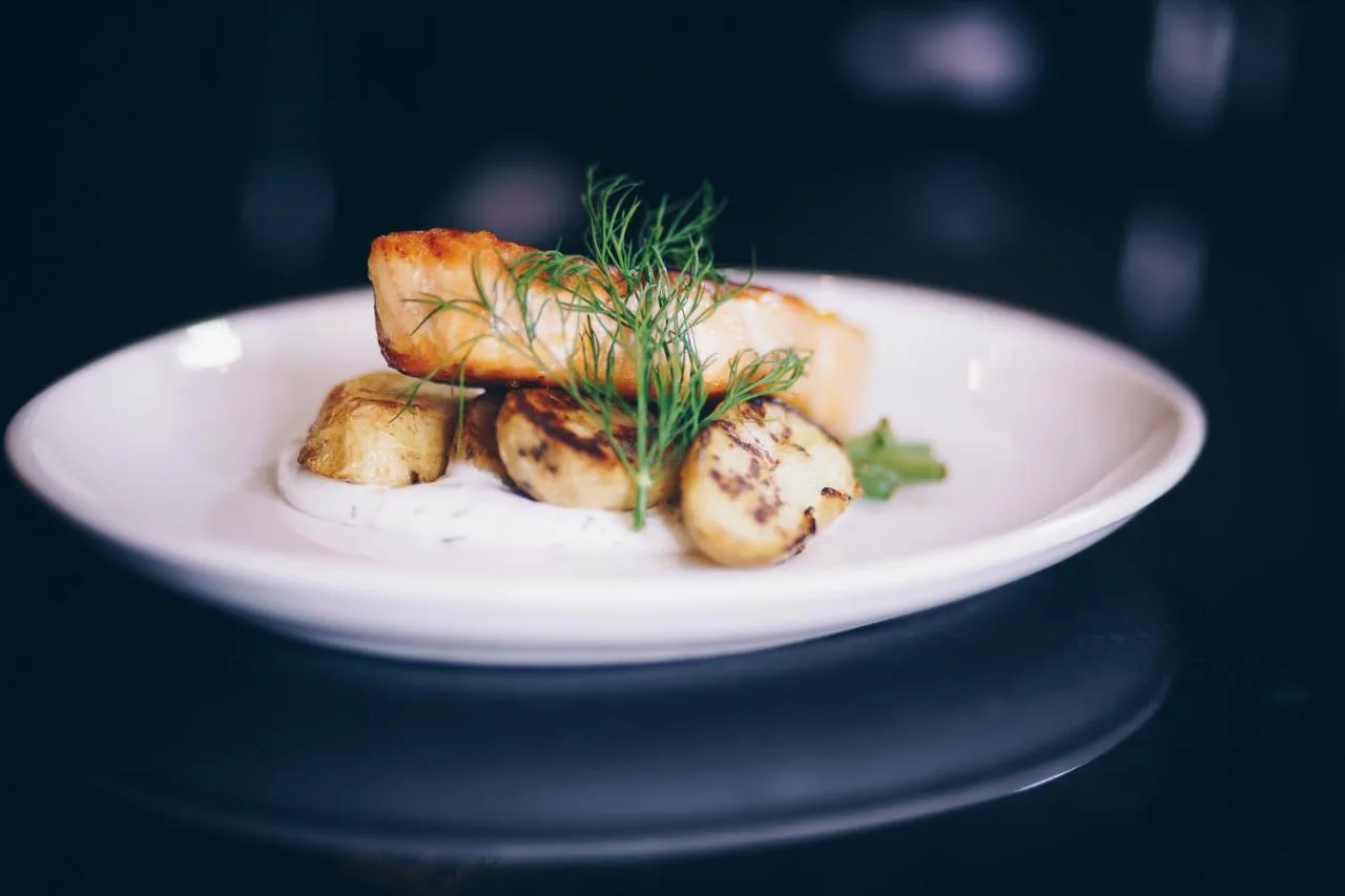 a white plate with some food on a table at The County Aparthotel in Newcastle upon Tyne